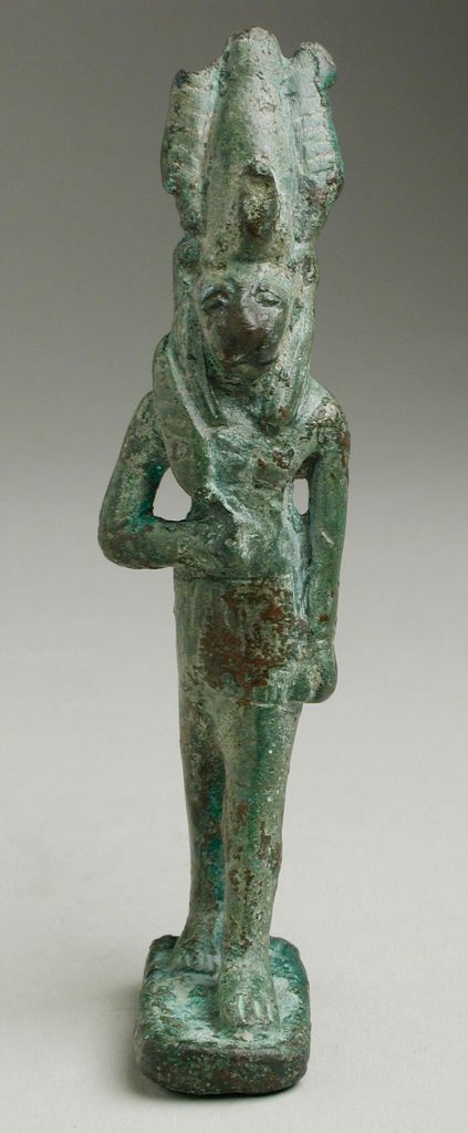 Greenish bronze statue of a man with a lion head holding a knife.