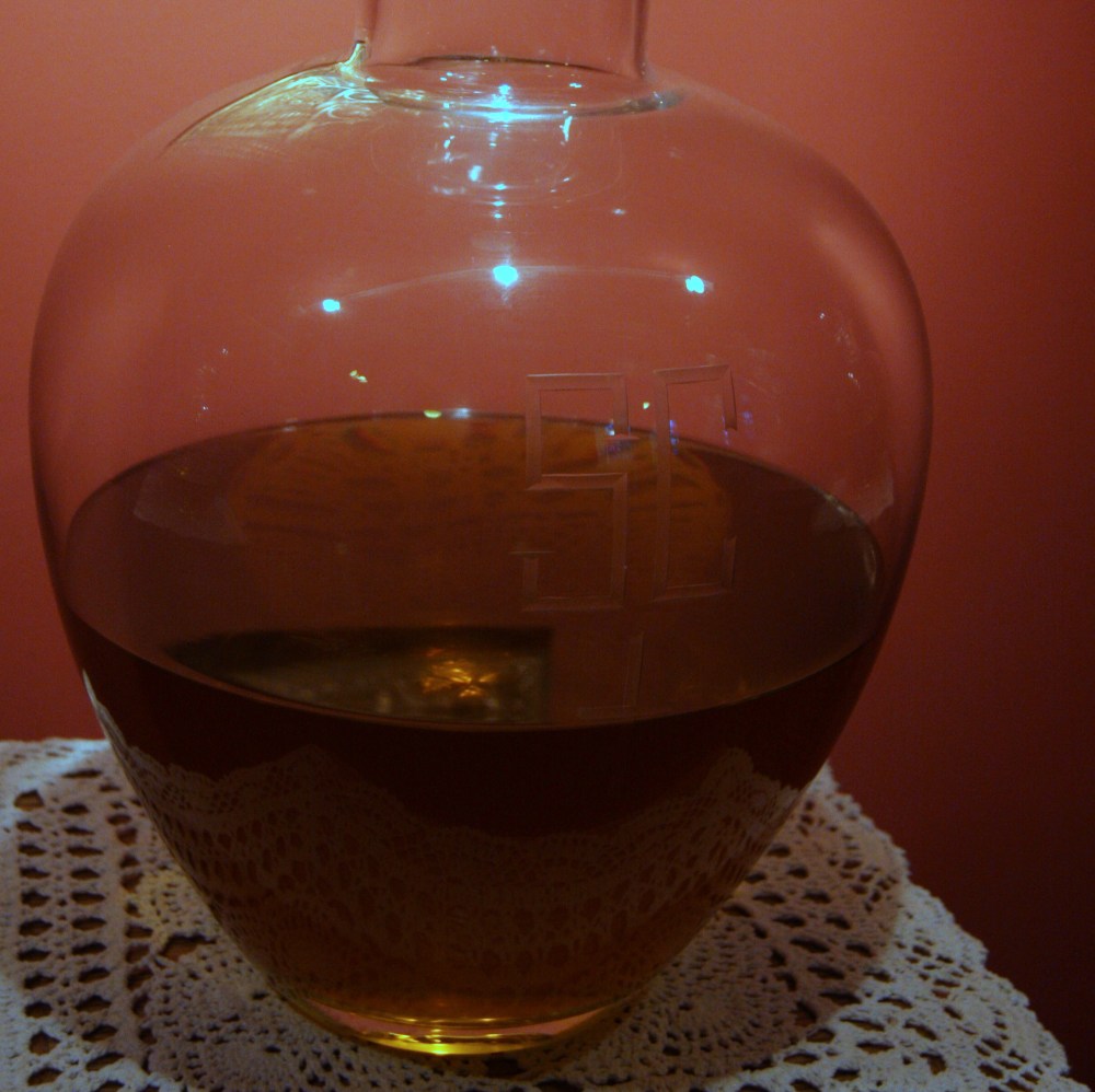 Large glass bottle of Chrism